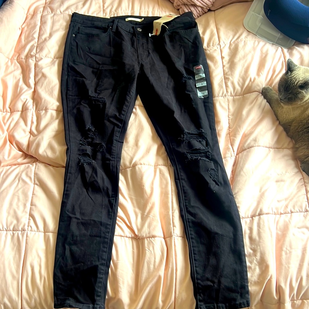 Levi’s 711 Black skinny jeans with tears at knees
